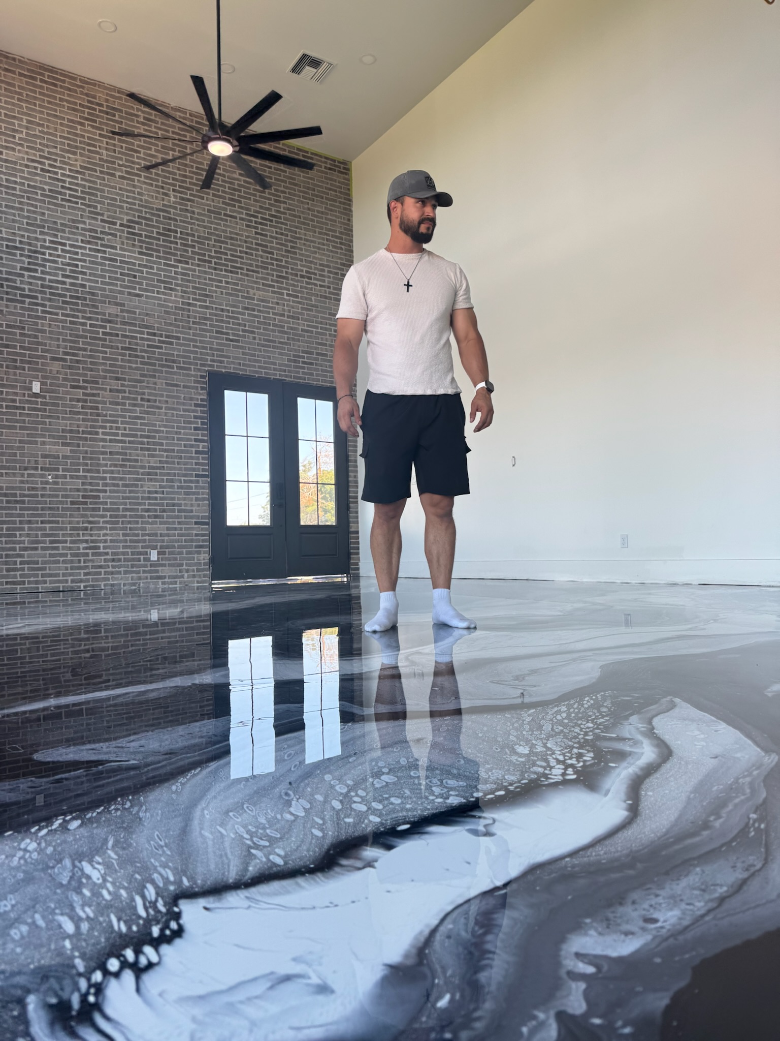 Tru Coat Epoxy team member working on premium metallic floor installation